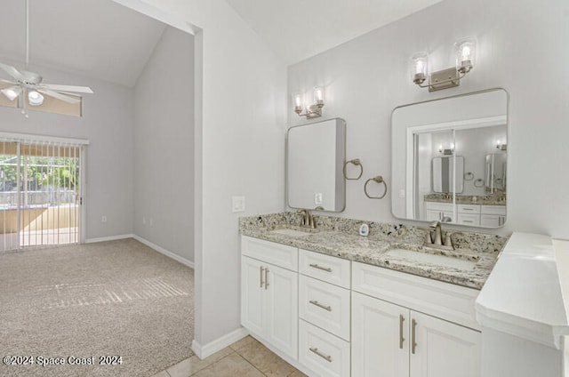 bathroom featuring tile patterned flooring, vaulted ceiling, ceiling fan, and vanity