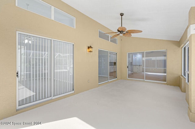 unfurnished sunroom with vaulted ceiling and ceiling fan