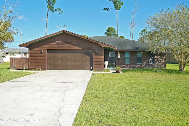 ranch-style home featuring a front lawn and a garage