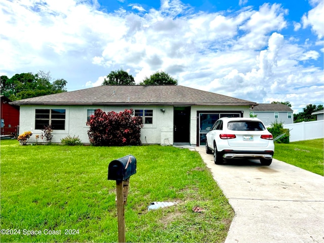 ranch-style home with a garage and a front yard