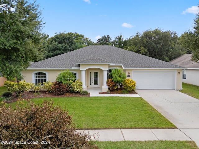 ranch-style home featuring a garage and a front yard