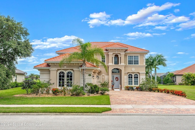 mediterranean / spanish-style house with a front lawn