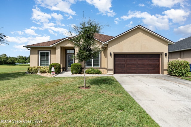 ranch-style house featuring a front lawn and a garage