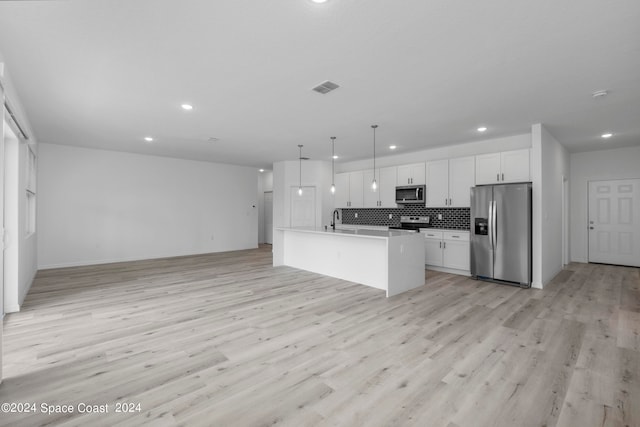 kitchen with stainless steel appliances, open floor plan, white cabinetry, visible vents, and recessed lighting