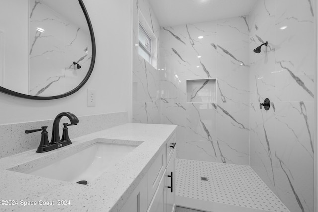 bathroom featuring walk in shower and vanity