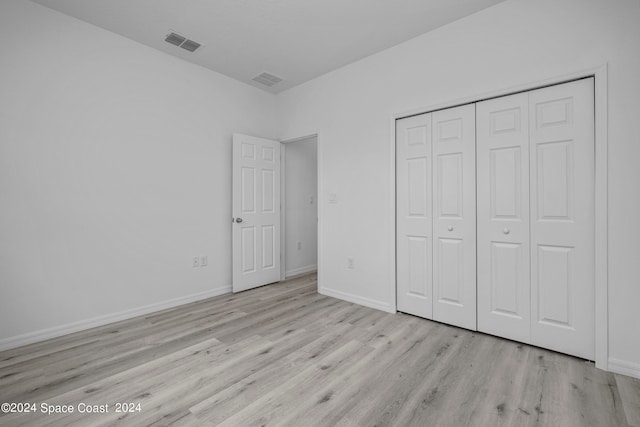 unfurnished bedroom with baseboards, visible vents, and wood finished floors