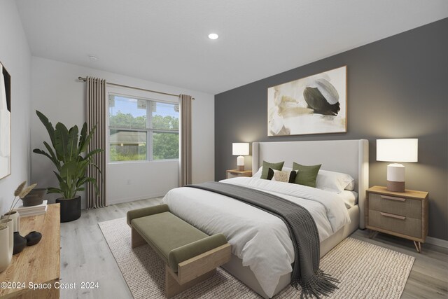 bedroom featuring baseboards, light wood finished floors, and recessed lighting