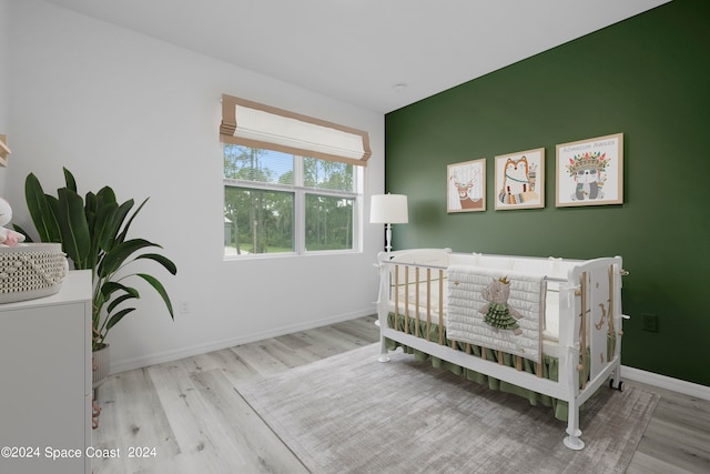 bedroom featuring baseboards and wood finished floors