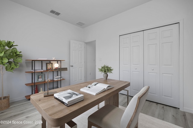 office featuring baseboards, light wood-type flooring, and visible vents
