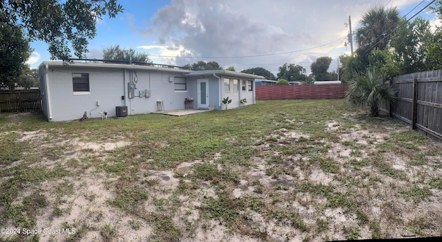 rear view of property featuring a yard