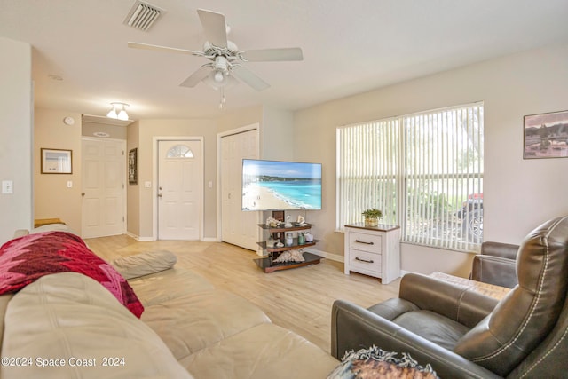 living room with ceiling fan and light hardwood / wood-style flooring