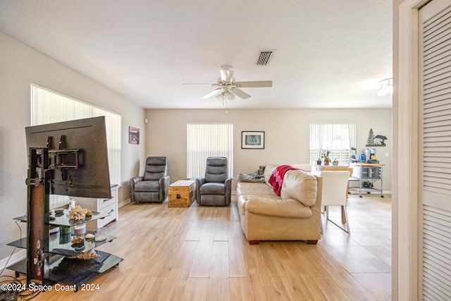 living room featuring light wood-type flooring and ceiling fan