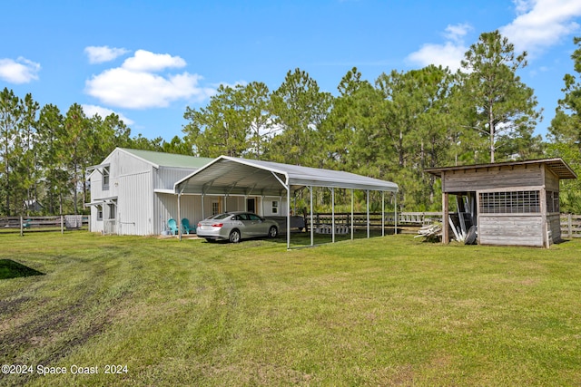 view of yard with a carport and an outdoor structure