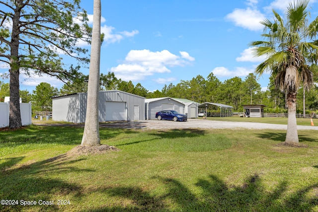 view of yard featuring an outdoor structure and a garage