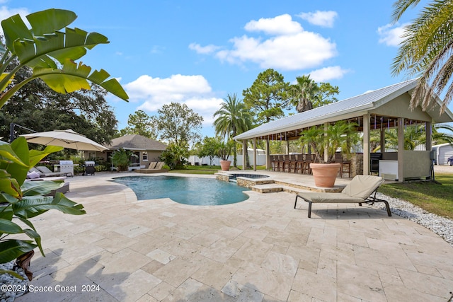 view of swimming pool with a patio, an in ground hot tub, and exterior bar