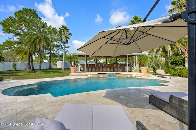 view of swimming pool with a gazebo, a bar, and a patio area