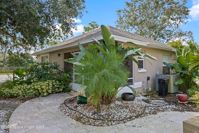 view of property exterior with central AC and a patio area