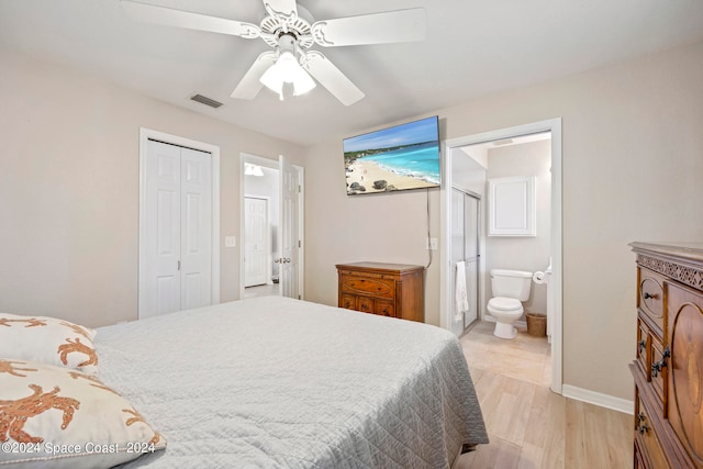 bedroom with light hardwood / wood-style flooring, a closet, ceiling fan, and ensuite bathroom