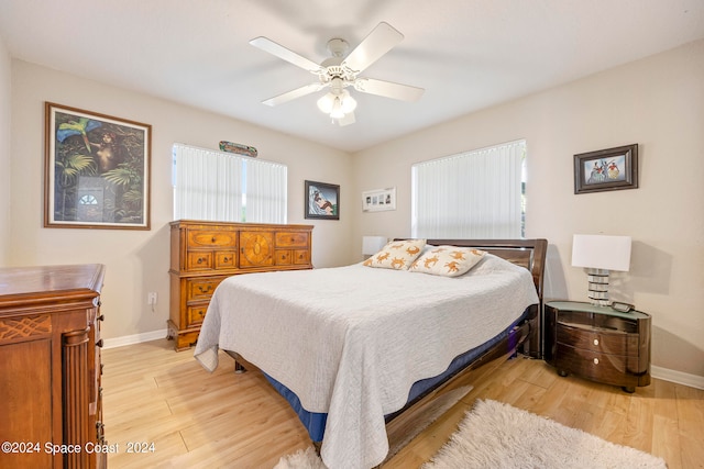 bedroom with light hardwood / wood-style flooring and ceiling fan