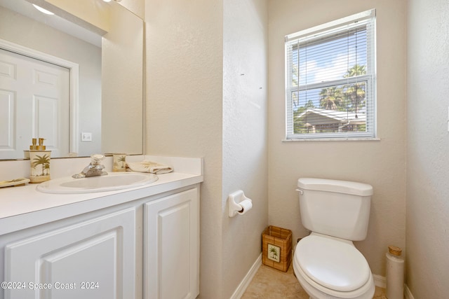 bathroom featuring tile patterned floors, vanity, and toilet