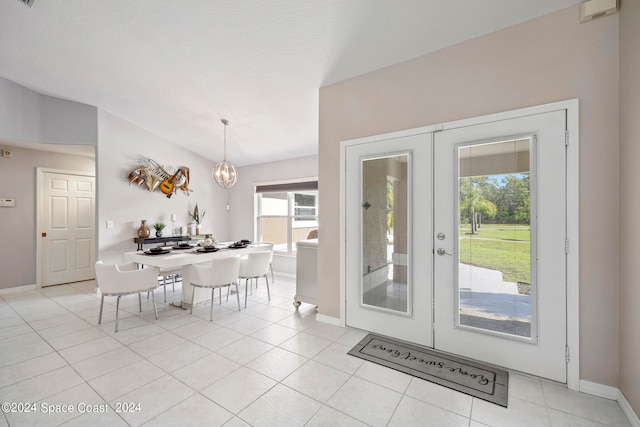 tiled foyer with french doors and a healthy amount of sunlight