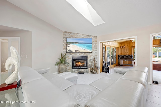 living room with a fireplace and lofted ceiling with skylight