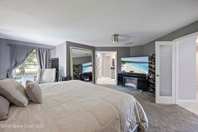 carpeted bedroom featuring ensuite bathroom