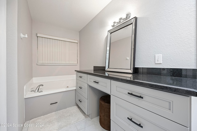 bathroom featuring vanity, tile patterned flooring, and a bathtub