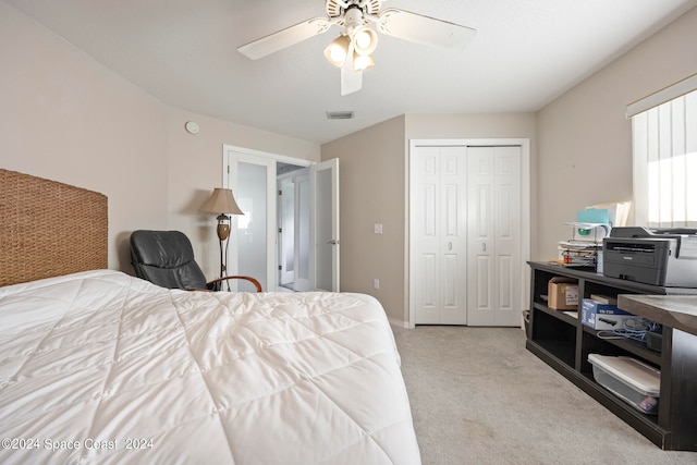 bedroom featuring ceiling fan, light colored carpet, and a closet