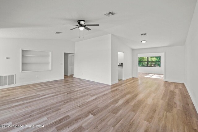 unfurnished living room featuring light hardwood / wood-style floors, ceiling fan, vaulted ceiling, and built in features