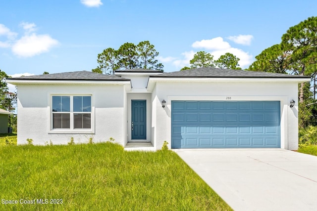 view of front of home featuring a front lawn and a garage