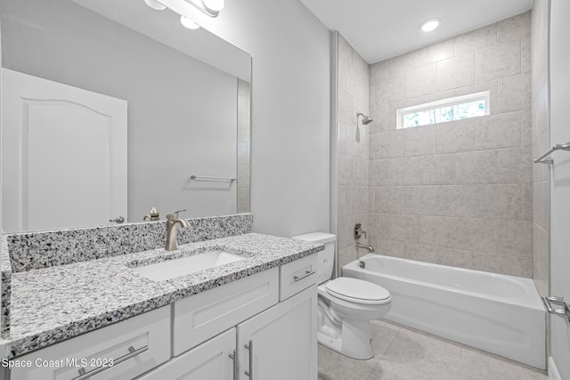 full bathroom featuring tiled shower / bath combo, vanity, toilet, and tile patterned floors