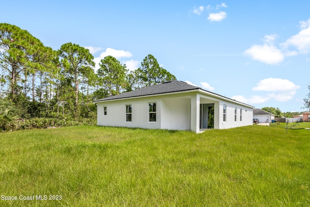 view of side of property with a yard