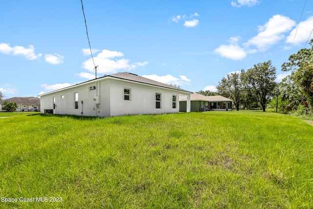 view of side of property with a lawn