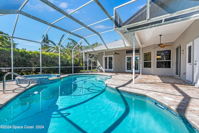 view of pool featuring ceiling fan, glass enclosure, an in ground hot tub, and a patio area