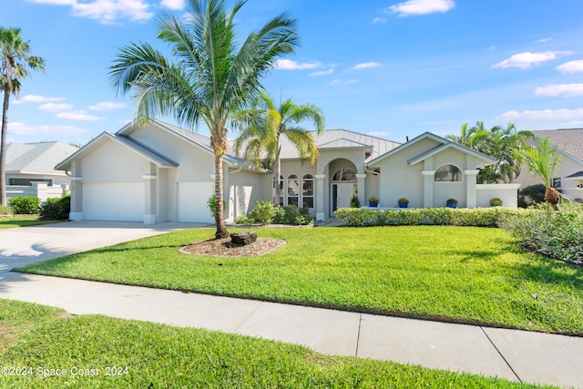 view of front facade with a garage and a front yard