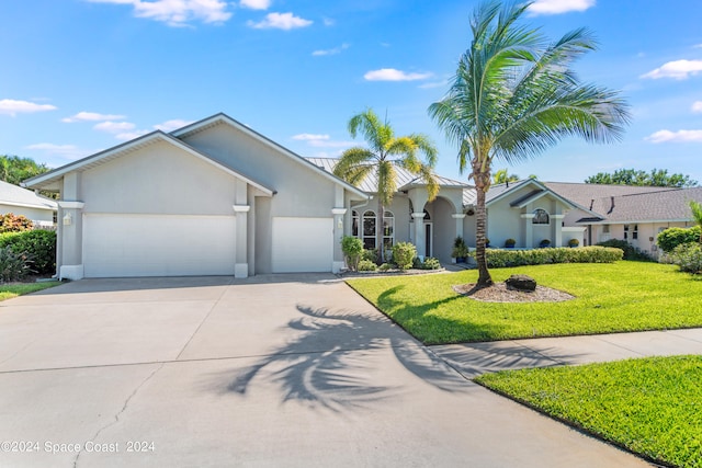 ranch-style home with a garage and a front lawn