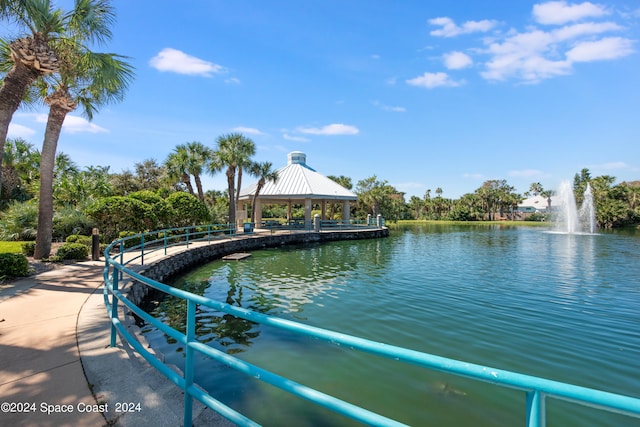 view of swimming pool with a gazebo and a water view