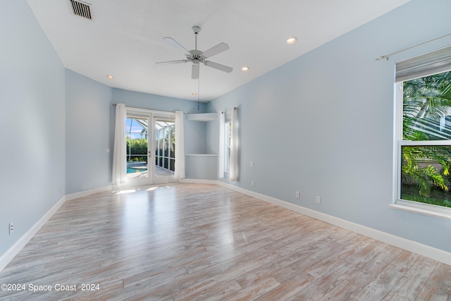 spare room with ceiling fan and light hardwood / wood-style flooring