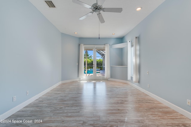 spare room with ceiling fan, light hardwood / wood-style flooring, and french doors