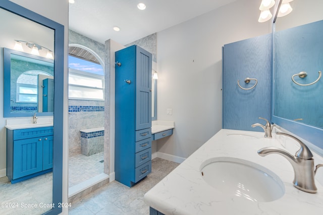 bathroom with vanity and tiled shower