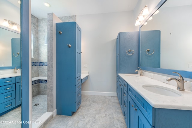 bathroom featuring a tile shower and vanity