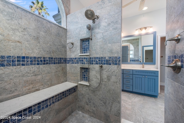 bathroom with vanity and tiled shower