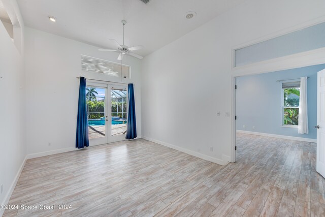 unfurnished room featuring french doors, light hardwood / wood-style floors, and ceiling fan