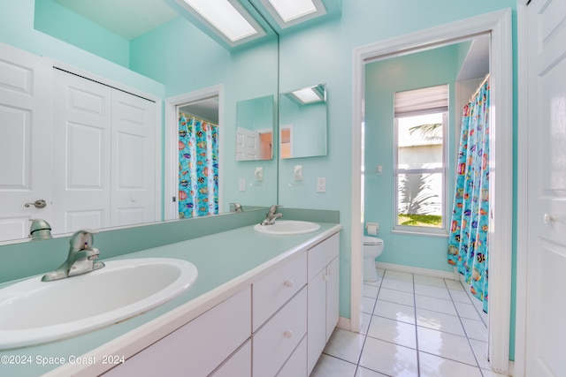 bathroom featuring tile patterned floors, vanity, and toilet