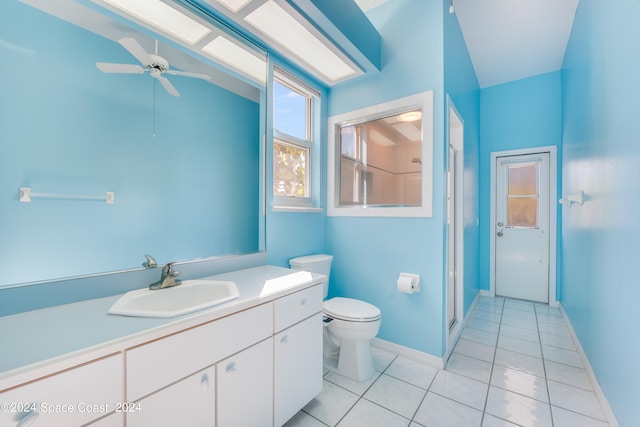 bathroom with tile patterned flooring, walk in shower, ceiling fan, toilet, and vanity