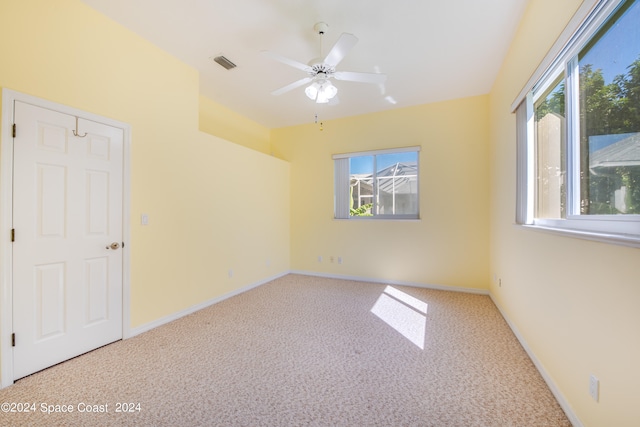 unfurnished room featuring ceiling fan, plenty of natural light, and carpet