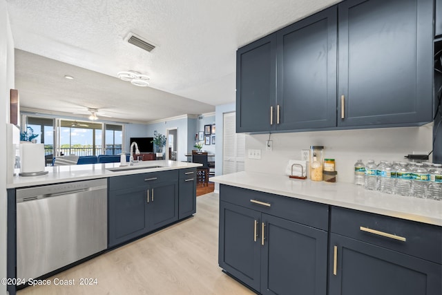 kitchen with ceiling fan, sink, stainless steel dishwasher, a textured ceiling, and light wood-type flooring