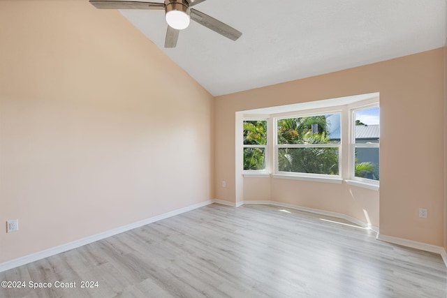 unfurnished room with light wood-type flooring, ceiling fan, and lofted ceiling