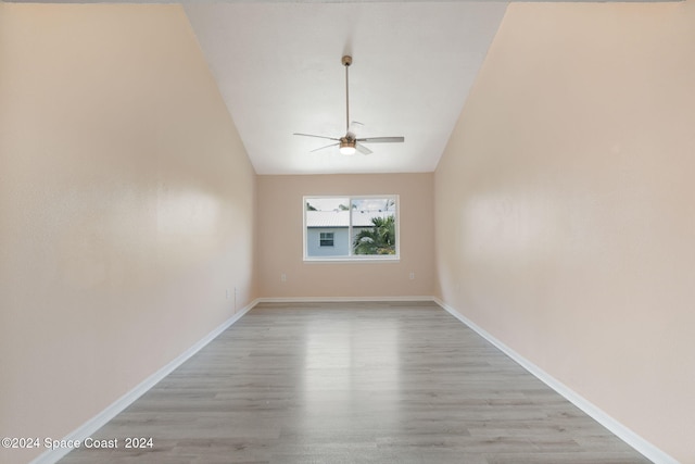 unfurnished room with light hardwood / wood-style flooring, ceiling fan, and lofted ceiling